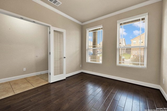 unfurnished room with plenty of natural light, hardwood / wood-style floors, french doors, and ornamental molding