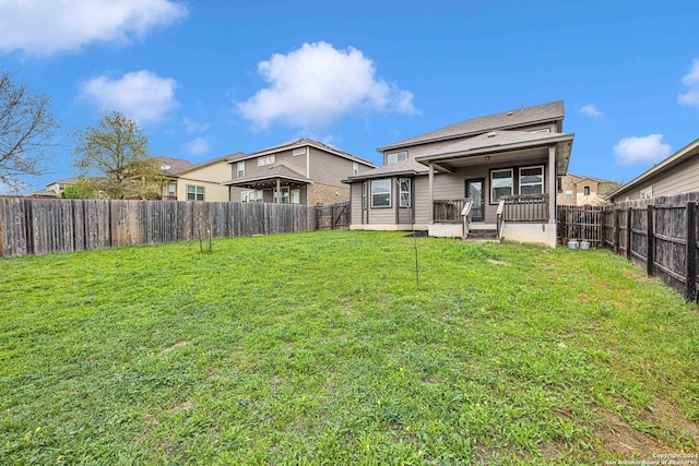 rear view of property with a yard