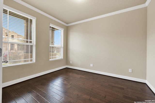 empty room featuring dark hardwood / wood-style flooring and ornamental molding