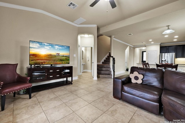 living room with light tile patterned floors, vaulted ceiling, ceiling fan, and ornamental molding