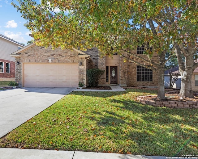 view of front of home with a garage and a front yard