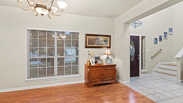 foyer with a chandelier and light hardwood / wood-style floors