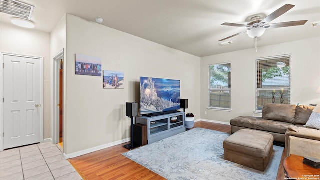 living room with ceiling fan and light hardwood / wood-style flooring