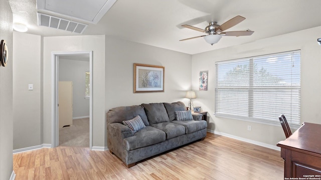 living room featuring ceiling fan and light hardwood / wood-style flooring