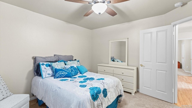 bedroom featuring ceiling fan and light colored carpet