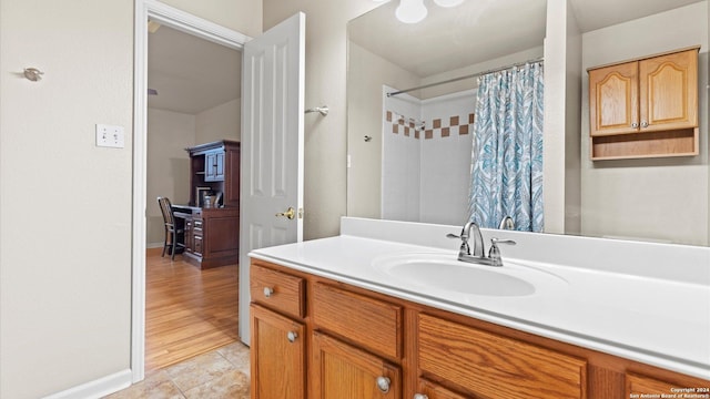 bathroom featuring a shower with shower curtain, hardwood / wood-style floors, and vanity