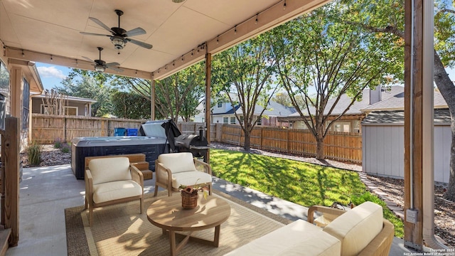 view of patio featuring ceiling fan, an outdoor living space, and a hot tub