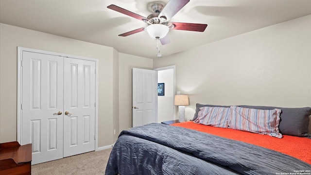 bedroom featuring ceiling fan, light carpet, and a closet