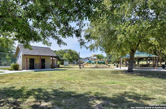 view of yard with a gazebo, a playground, and an outdoor structure