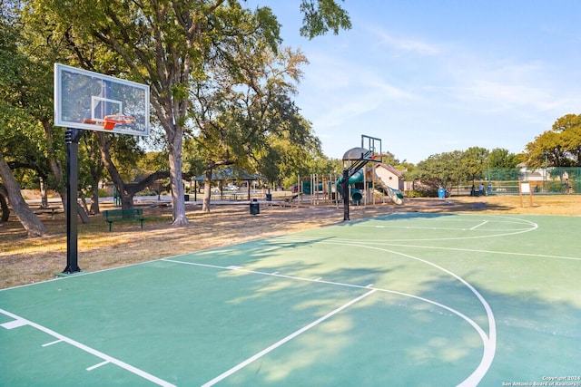 view of basketball court featuring a gazebo and a playground