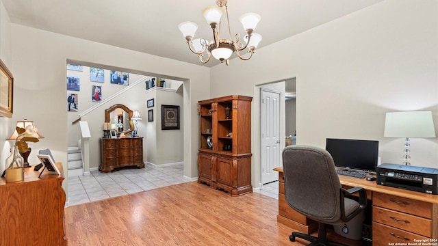 office featuring an inviting chandelier and light hardwood / wood-style flooring