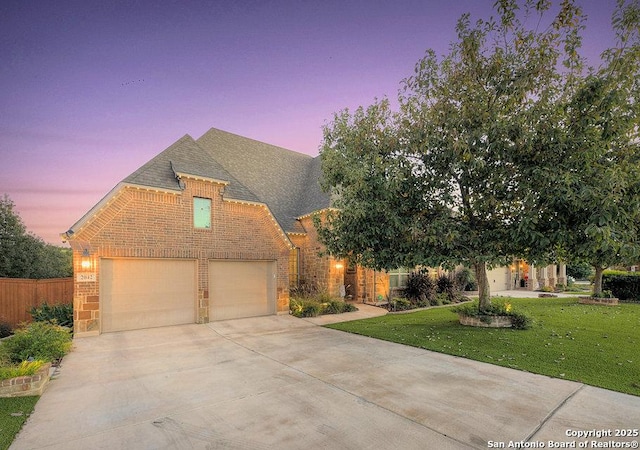 view of front of property featuring a lawn and a garage