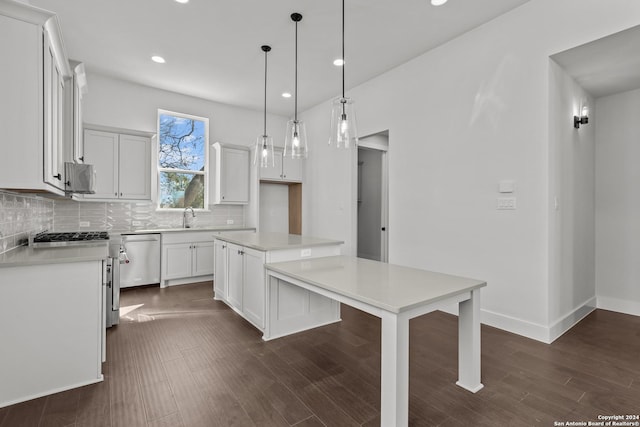 kitchen with stainless steel appliances, a center island, dark hardwood / wood-style floors, white cabinetry, and hanging light fixtures