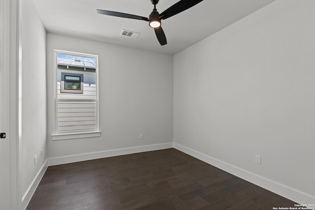 unfurnished room with dark hardwood / wood-style flooring and ceiling fan