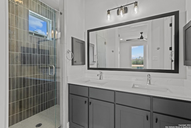 bathroom with vanity, ceiling fan, and walk in shower