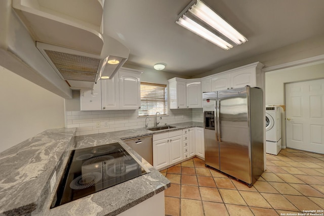 kitchen featuring decorative backsplash, appliances with stainless steel finishes, sink, white cabinets, and washer / clothes dryer