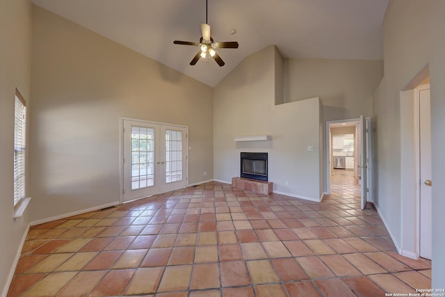 unfurnished living room with ceiling fan, french doors, high vaulted ceiling, and light tile patterned floors