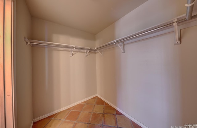 walk in closet with tile patterned floors