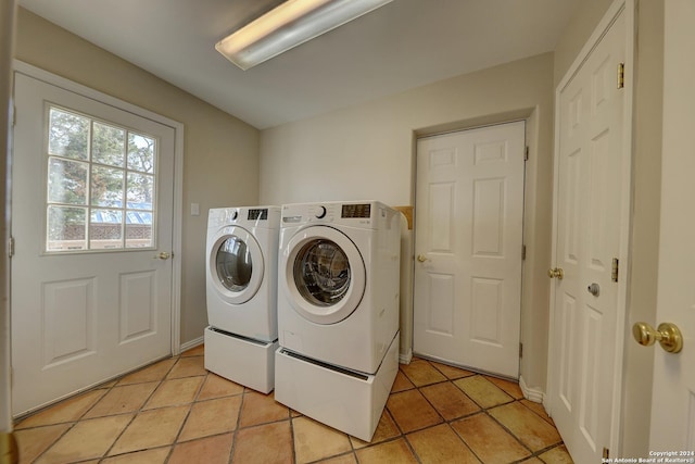 laundry room with light tile patterned floors and separate washer and dryer