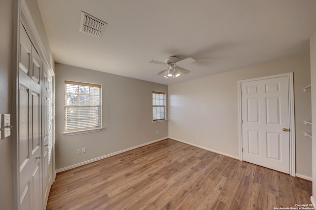 unfurnished bedroom with ceiling fan and light hardwood / wood-style flooring