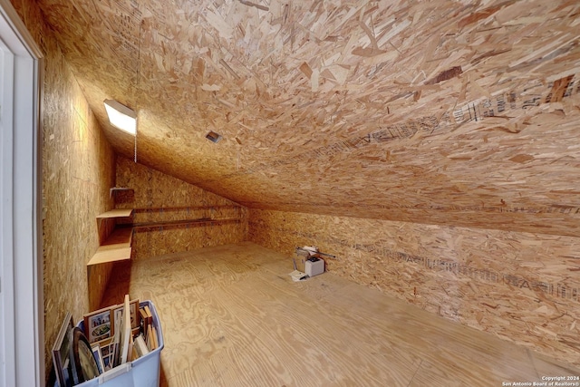 additional living space featuring lofted ceiling