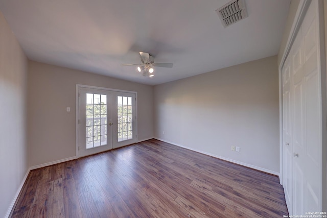 unfurnished room featuring ceiling fan, dark wood-type flooring, and french doors