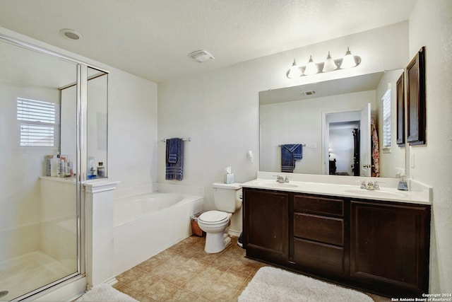 full bathroom featuring vanity, a textured ceiling, toilet, and independent shower and bath