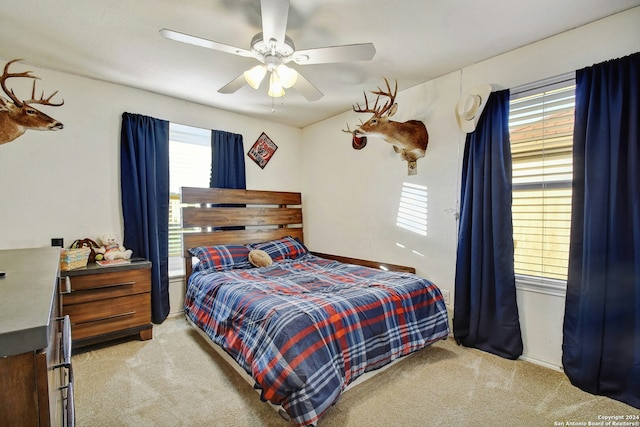 bedroom featuring ceiling fan and light carpet