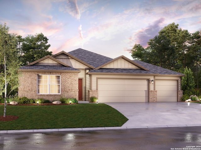 view of front of property with a lawn and a garage