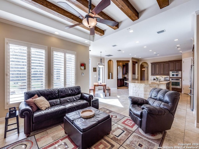 living area with arched walkways, light tile patterned flooring, visible vents, beam ceiling, and crown molding