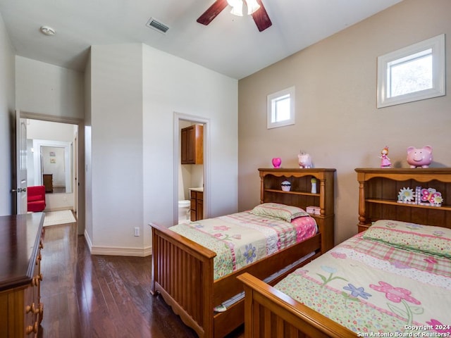 bedroom with baseboards, visible vents, ceiling fan, dark wood-style flooring, and ensuite bathroom