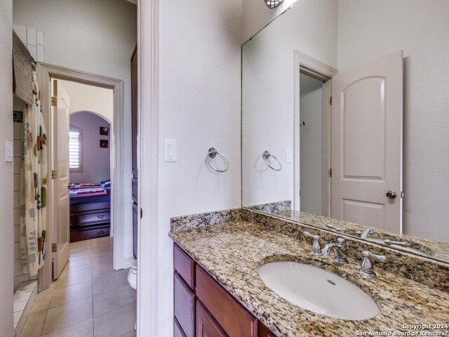 full bathroom with tile patterned flooring and vanity