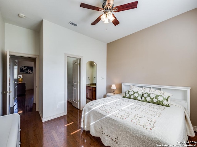 bedroom featuring arched walkways, dark wood-style flooring, visible vents, ceiling fan, and baseboards