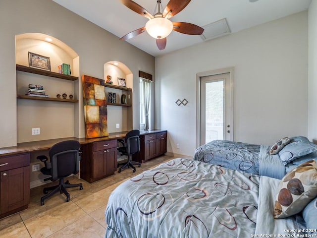 bedroom with attic access, visible vents, a ceiling fan, built in desk, and light tile patterned flooring