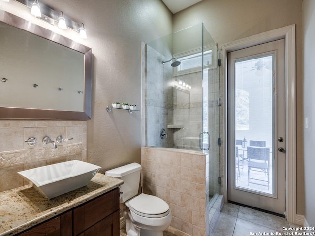 full bath with backsplash, toilet, a shower stall, vanity, and tile patterned floors