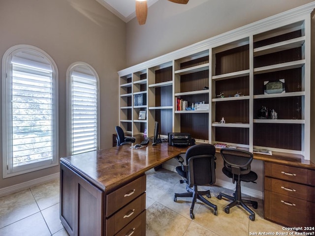 office space with ceiling fan, light tile patterned flooring, and baseboards