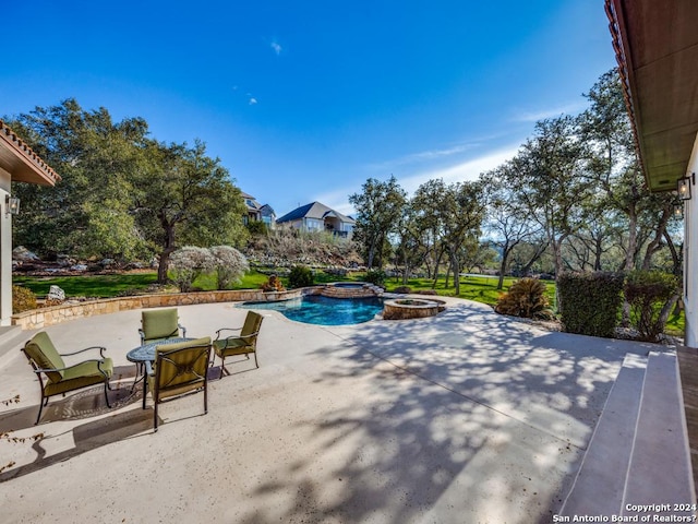 view of pool featuring a patio area and a pool with connected hot tub