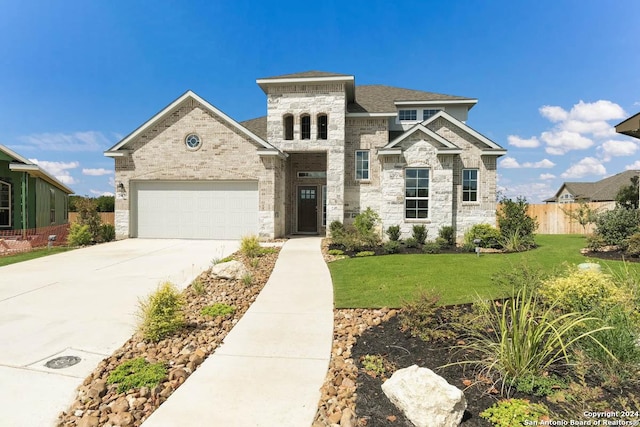 view of front of house with a garage and a front yard