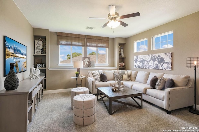 living room featuring ceiling fan and light carpet