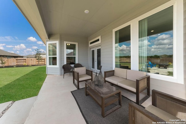 view of patio featuring outdoor lounge area, french doors, and radiator heating unit