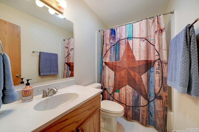 bathroom featuring tile patterned floors, vanity, and toilet