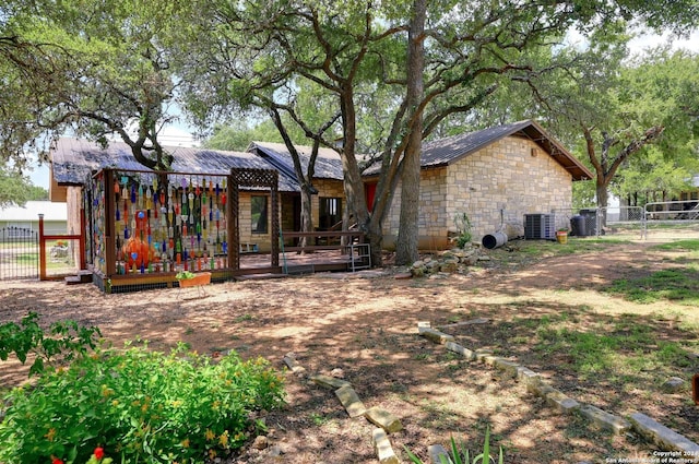 rear view of property with central AC unit and a deck