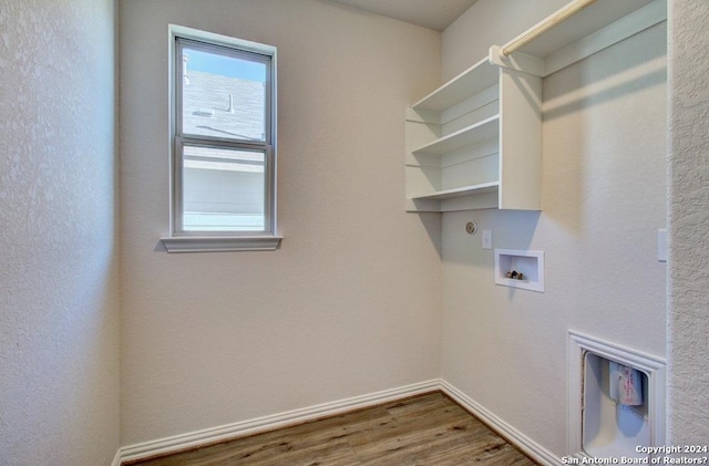 clothes washing area featuring hardwood / wood-style floors and hookup for a washing machine