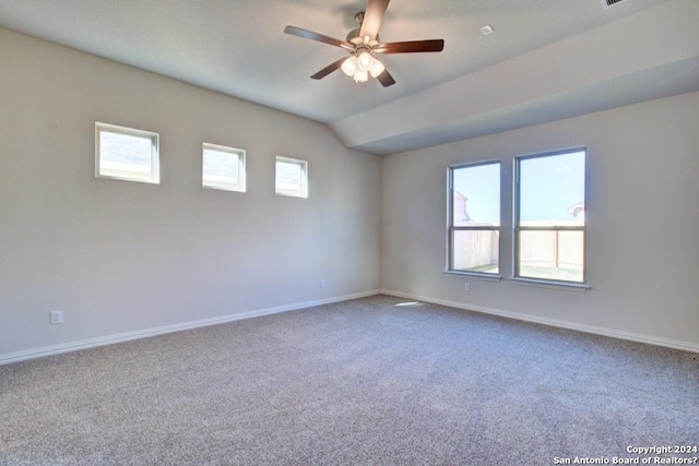 unfurnished room featuring carpet flooring, vaulted ceiling, and a healthy amount of sunlight