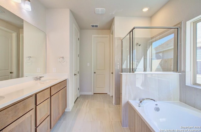 bathroom with tile patterned floors, vanity, separate shower and tub, and plenty of natural light