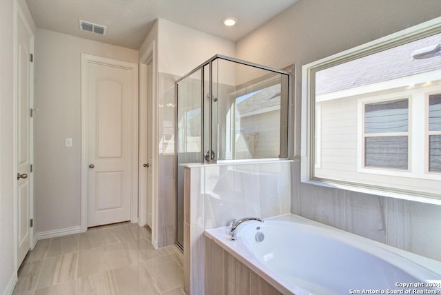 bathroom featuring independent shower and bath