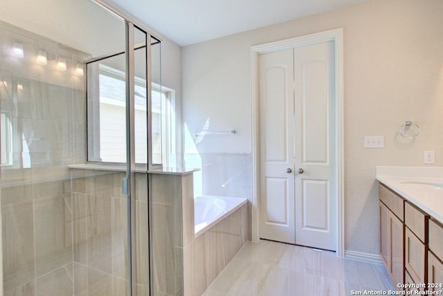 bathroom with tile patterned floors, vanity, and independent shower and bath