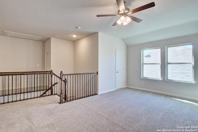 empty room featuring carpet flooring, ceiling fan, and vaulted ceiling