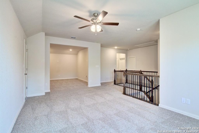 empty room with ceiling fan and light colored carpet