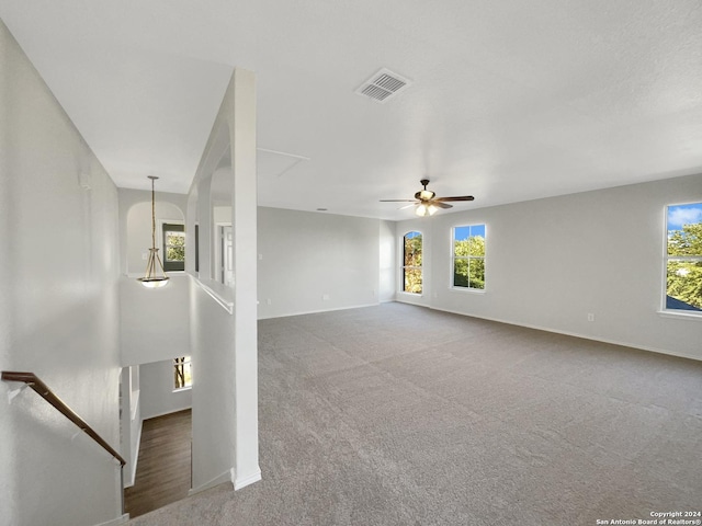 unfurnished living room with carpet flooring and ceiling fan